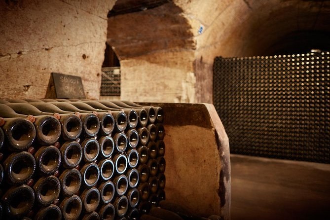 Bottles stacked on their sides in a niche cut into a chalk cellar